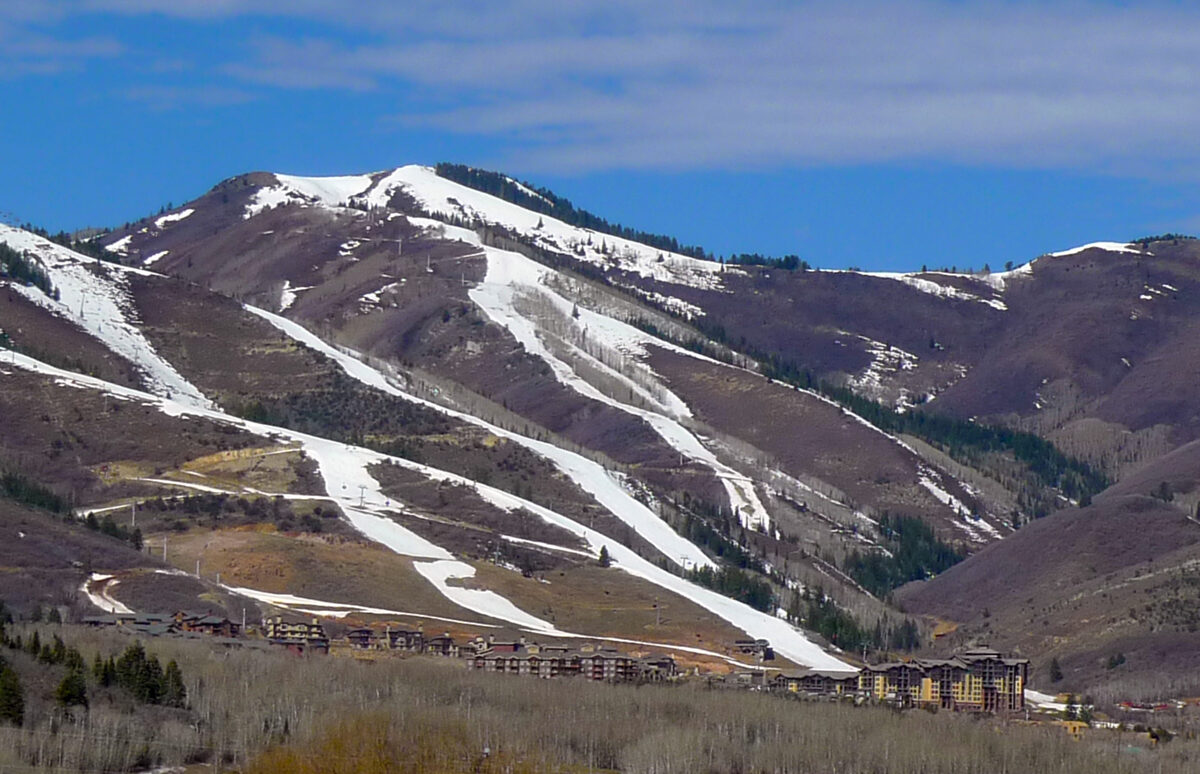 The ski runs of Canyons Resort above the hotels and condominiums of Canyons Village, with late-season snow on the slopes
