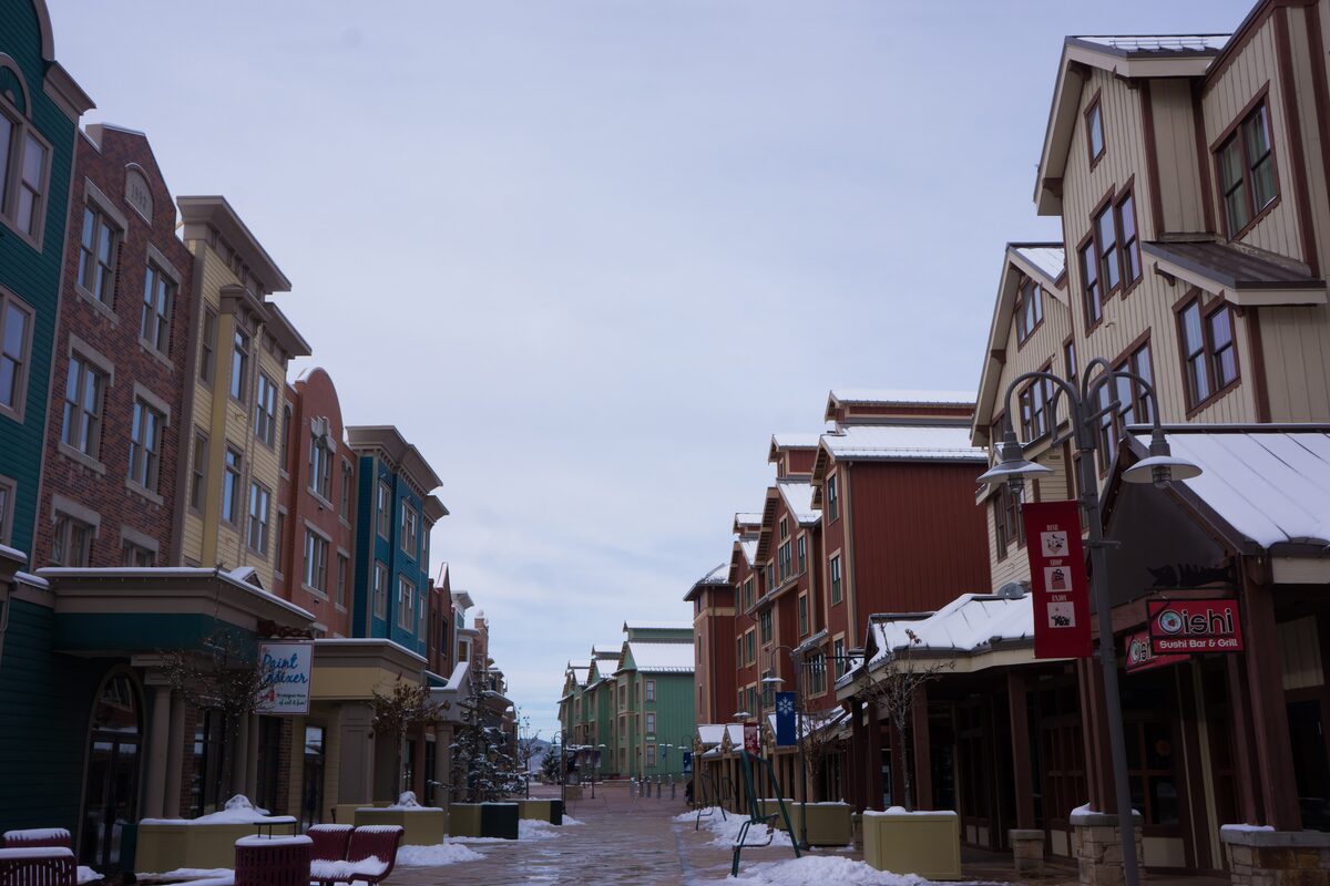 Main Street in Park City with colorful brick and clapboard buildings, and patches of snow left on the roofs and curbs