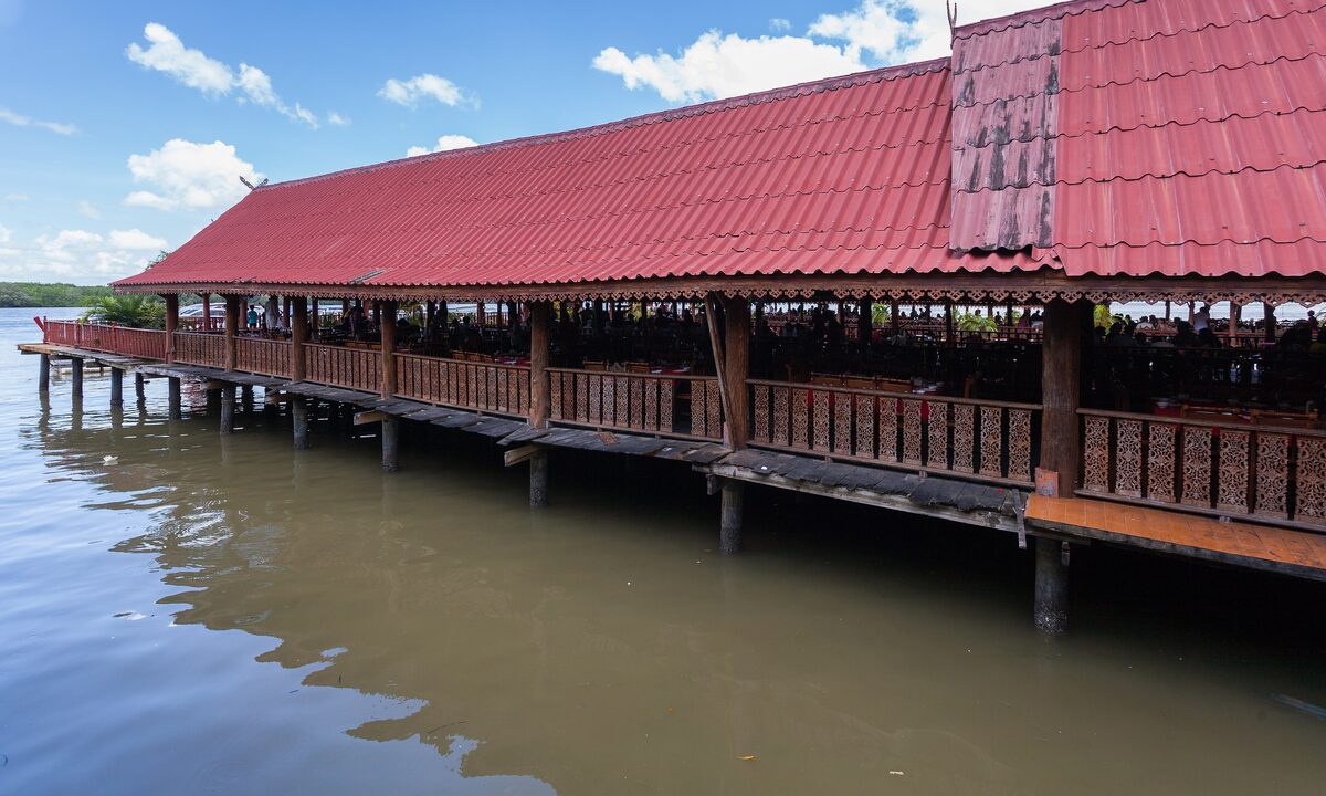 The long red-roofed wooden pier over the water on Ko Panyi, the stilt village in Phang Nga Bay