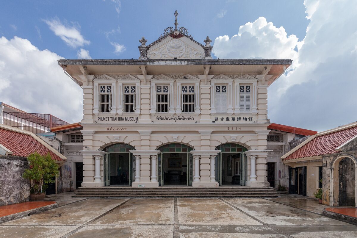 The white colonial facade of the Phuket Thai Hua Museum, a former school, with its name on the front