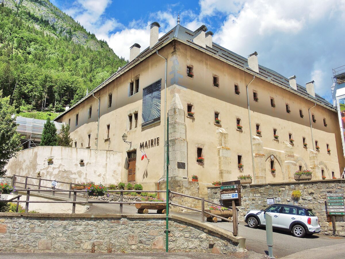 The large stone abbey buildings of Abondance, now the town hall and cultural center, on a summer day