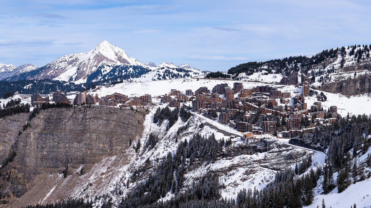 Avoriaz village from above, its apartment blocks on a snowy plateau under a peak