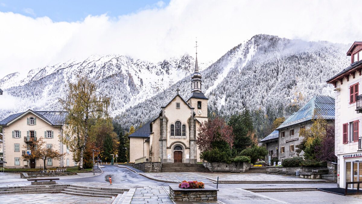 The church square in Chamonix with a first dusting of snow on the mountains behind