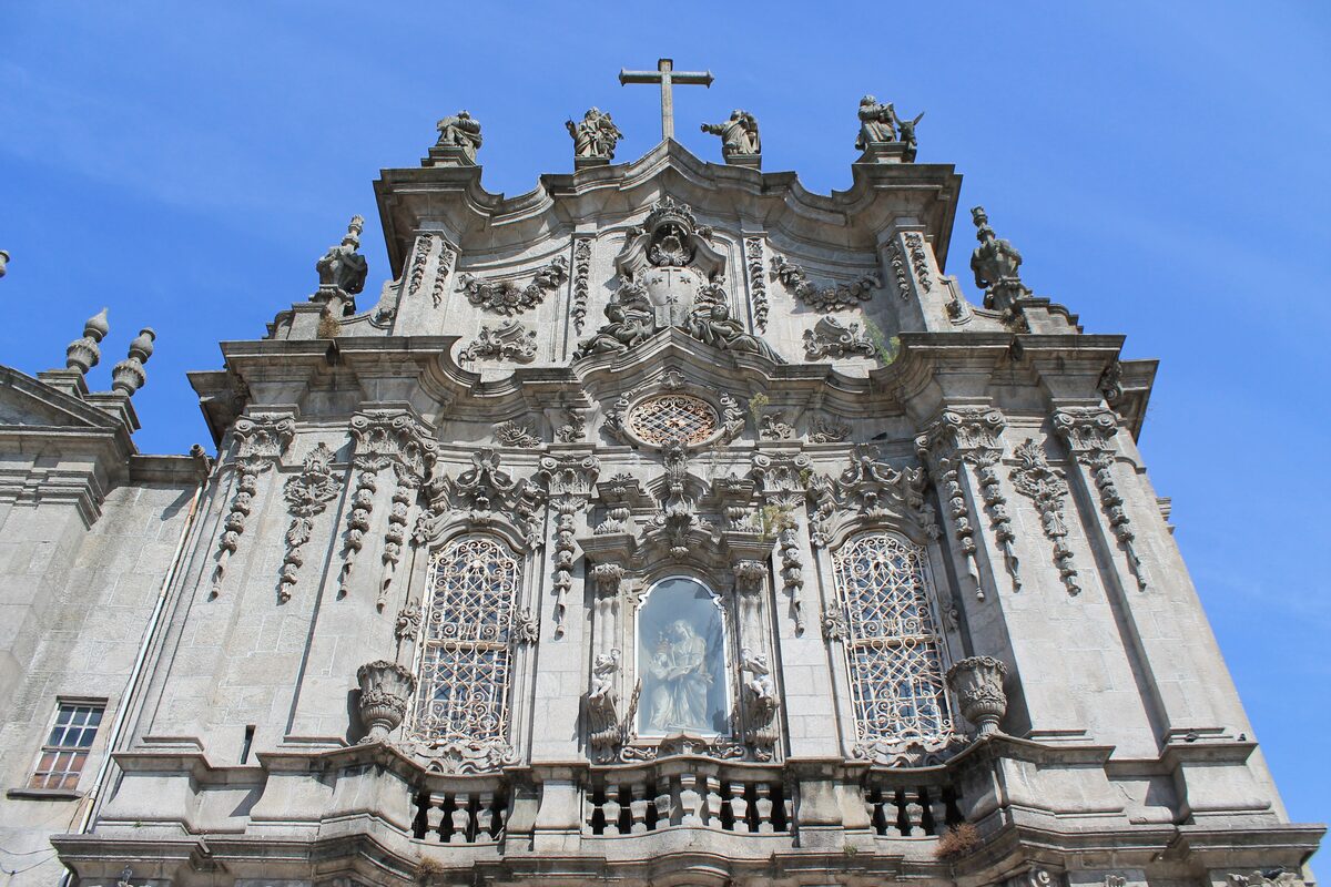 The ornate Baroque facade of the Igreja do Carmo, with carved stonework and a statue in a niche