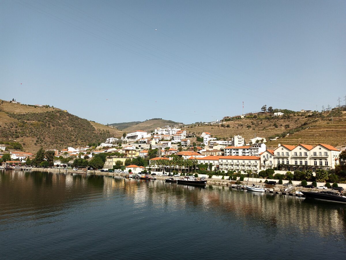 The village of Pinhão on the Douro, with white houses along the riverbank and terraced hills behind