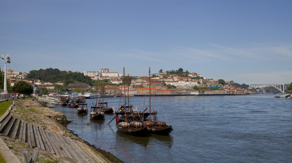Rabelo boats moored on the Douro with the hillside houses of the old town across the water
