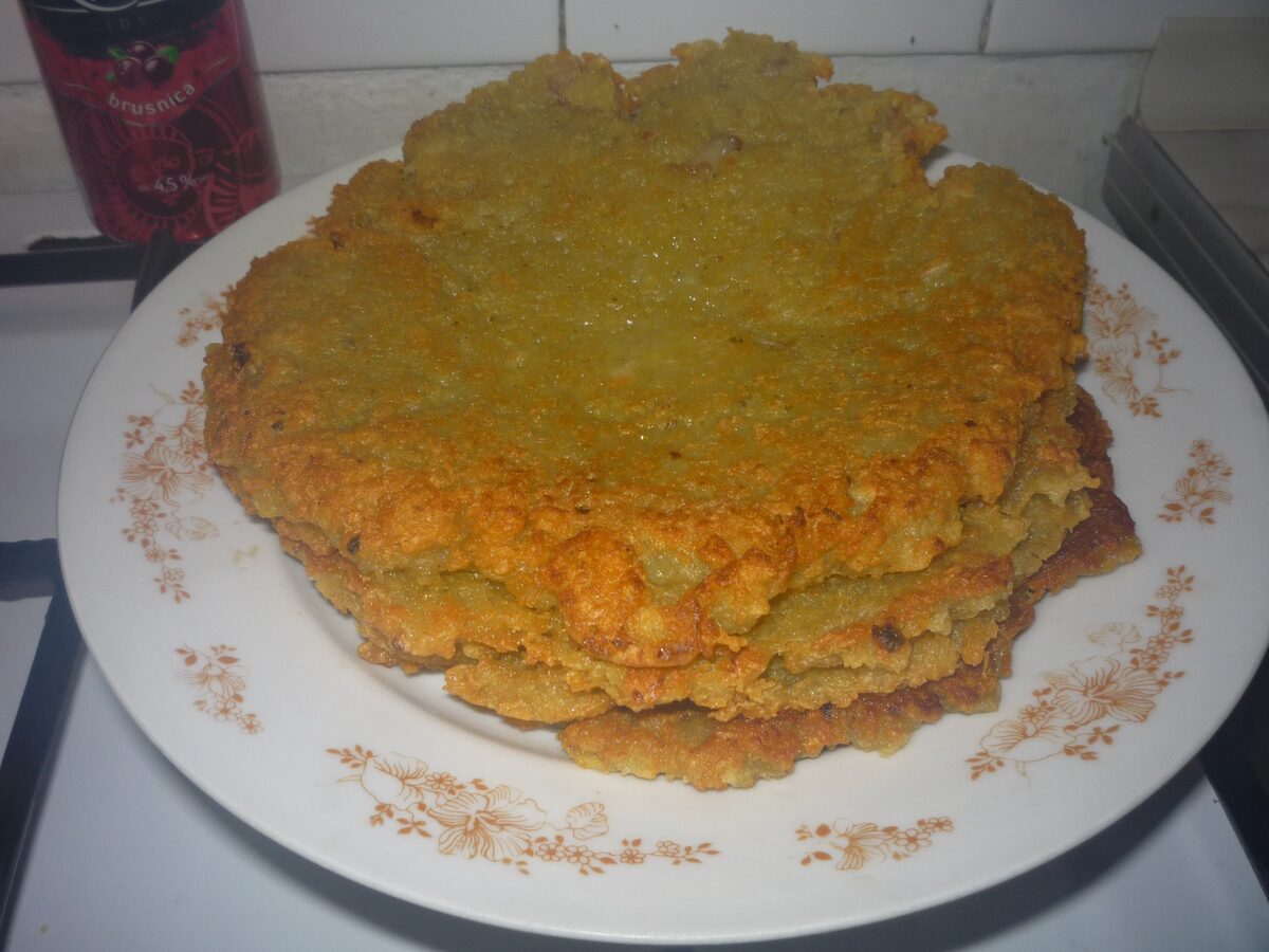 A stack of golden potato pancakes on a plate