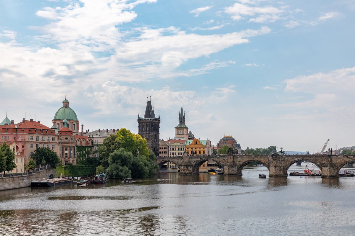 Charles Bridge's Gothic towers and arches across the Vltava with the Lesser Town riverside behind it