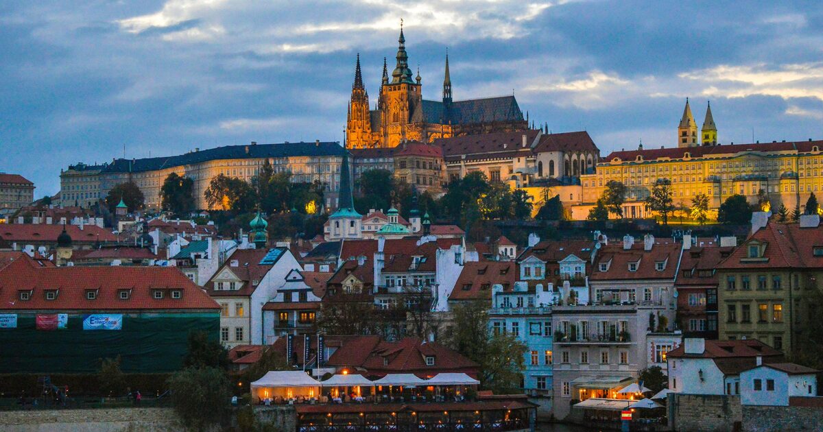 Prague Castle and the Lesser Town rooftops across the Vltava at dusk