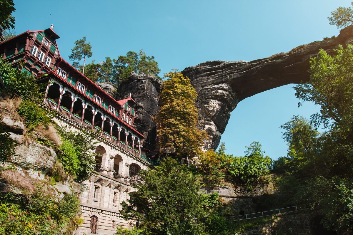 The Pravčická Gate sandstone arch, with a historic hotel built into the rock beneath it