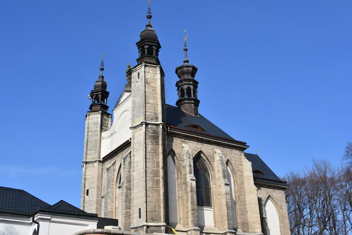 The Gothic church at the Sedlec Ossuary in Kutná Hora, with its twin towers against a blue sky