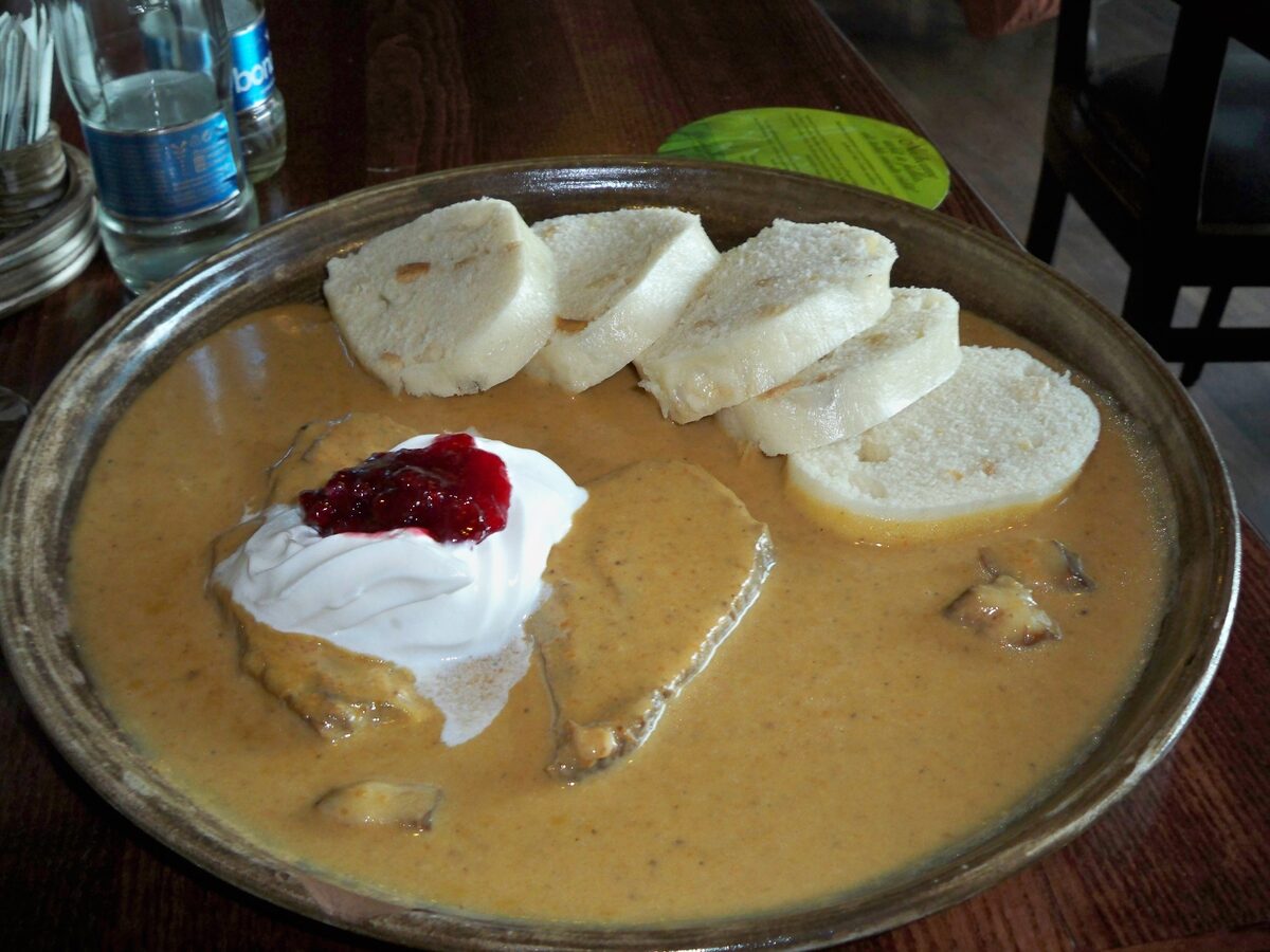 Svickova: sliced beef in creamy sauce with bread dumplings, cranberries and whipped cream