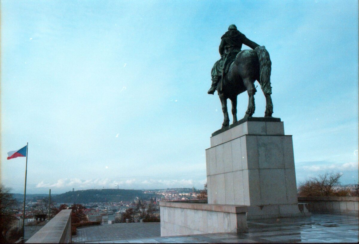 The bronze statue of the Hussite commander Jan Žižka on Vítkov Hill, with the city's hills behind it