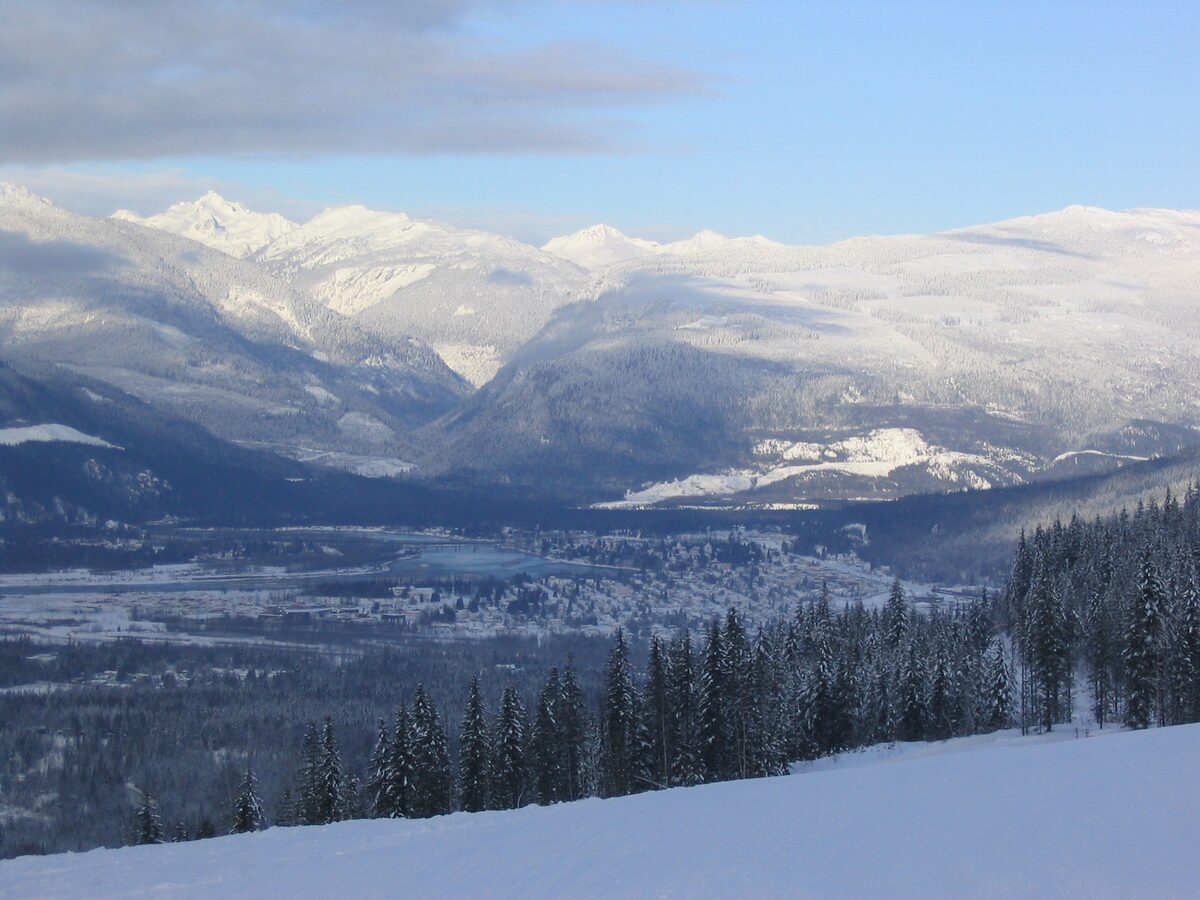 Snowy valley and mountains seen from a ski run