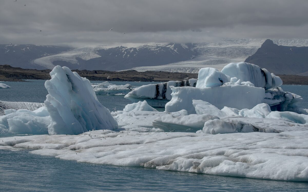 Icebergs floating in the Jökulsárlón glacier lagoon, with the glacier behind