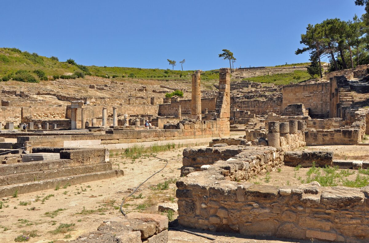 Stone colonnades and terraces of the ancient Doric city of Kamiros on the hillside