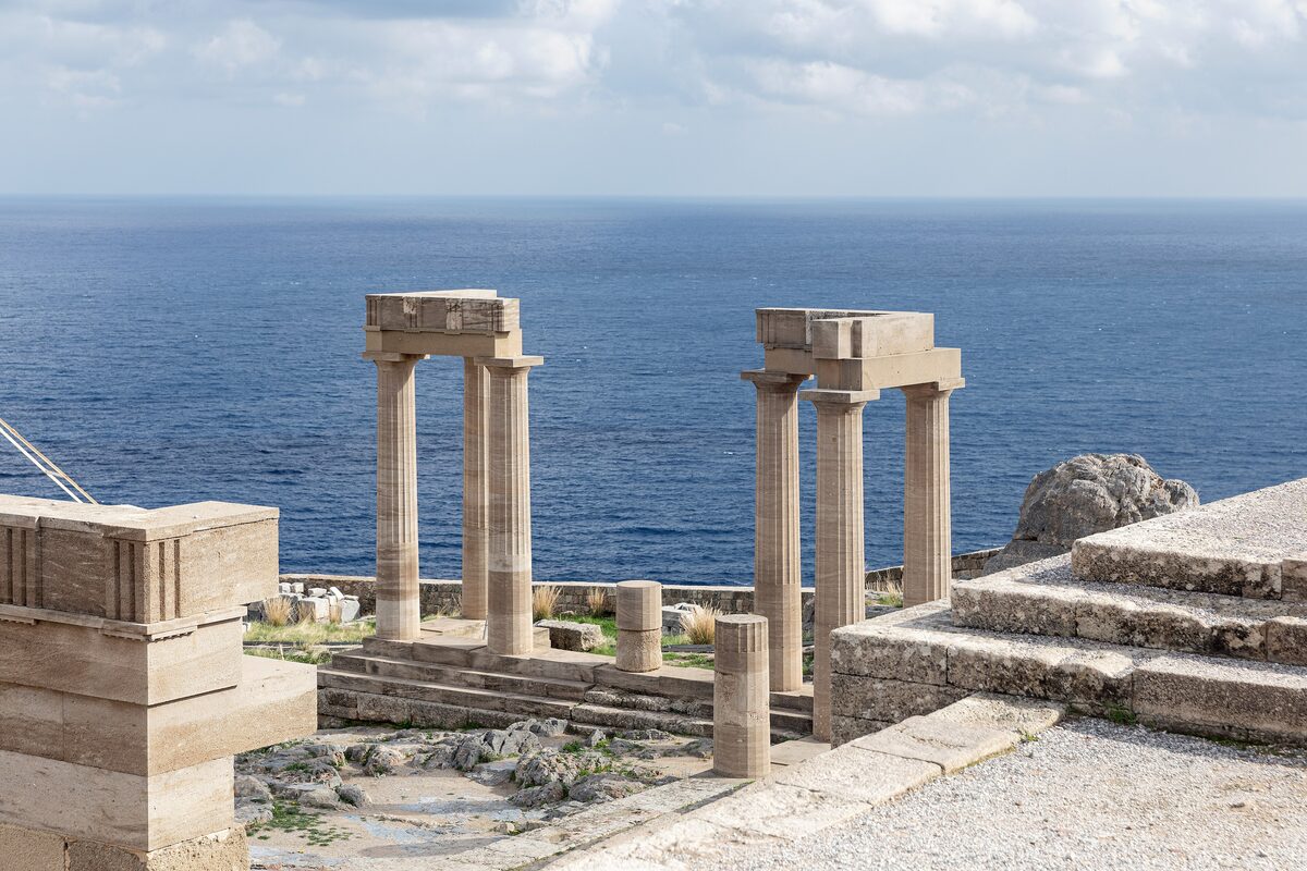 Two Doric columns of the Temple of Athena on the Lindos acropolis, with the sea behind them