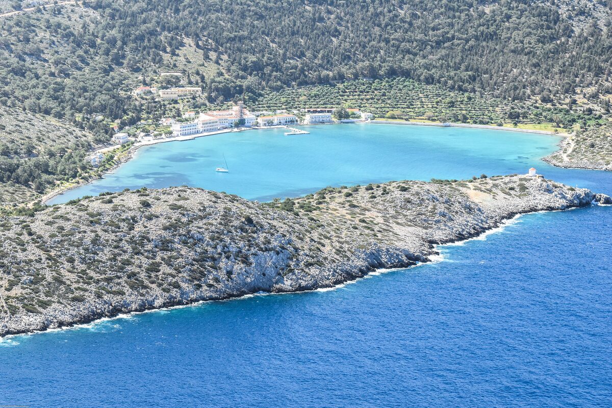 The turquoise bay of Panormitis on Symi, with the monastery buildings along the shore