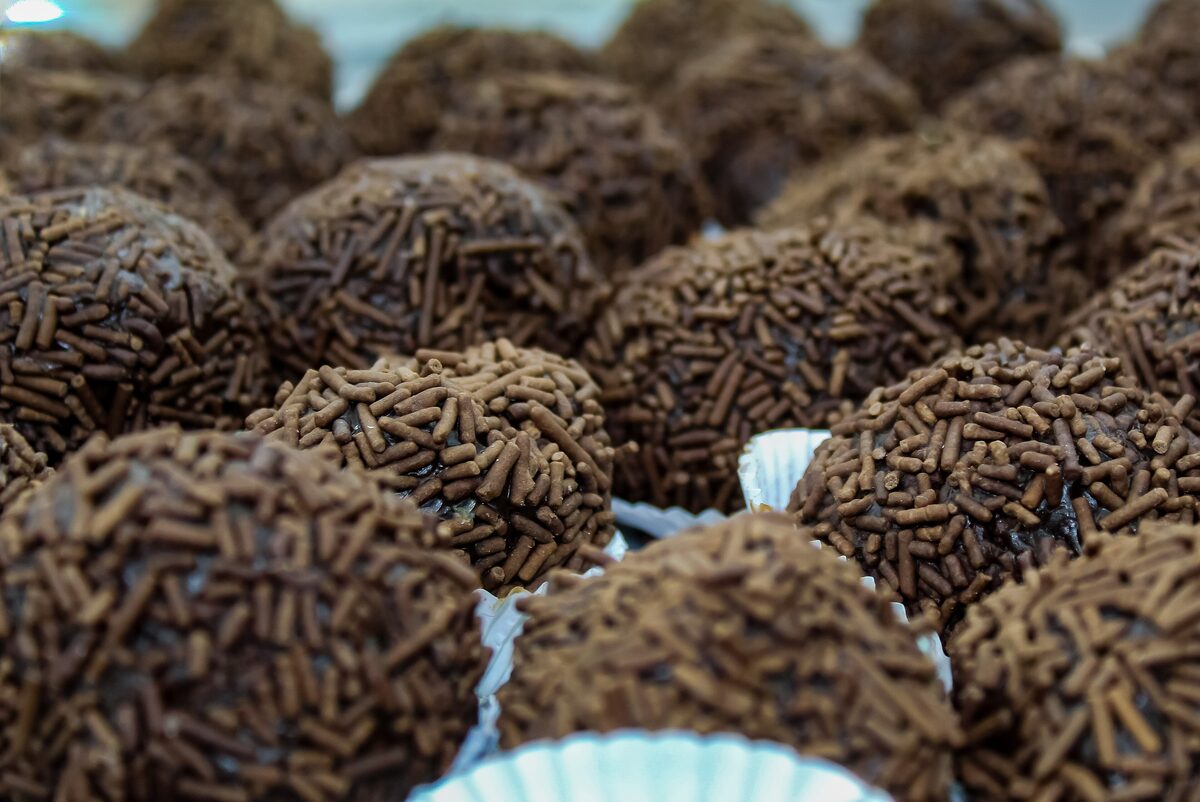Close-up of brigadeiros, chocolate balls rolled in chocolate sprinkles, in paper cups