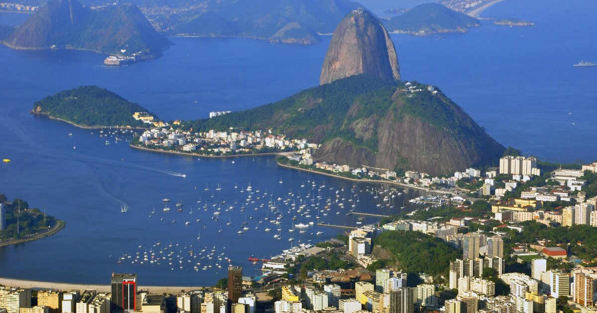 Sugarloaf rising from Guanabara Bay, with the curve of Botafogo bay, its boats and the city below, seen from Christ the Redeemer on a clear day