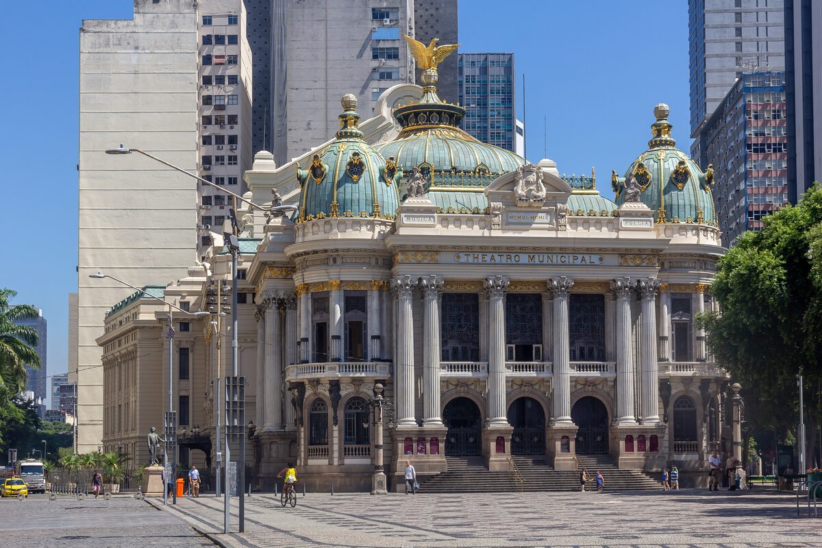 The Theatro Municipal facade with its green domes and columns on a sunny square