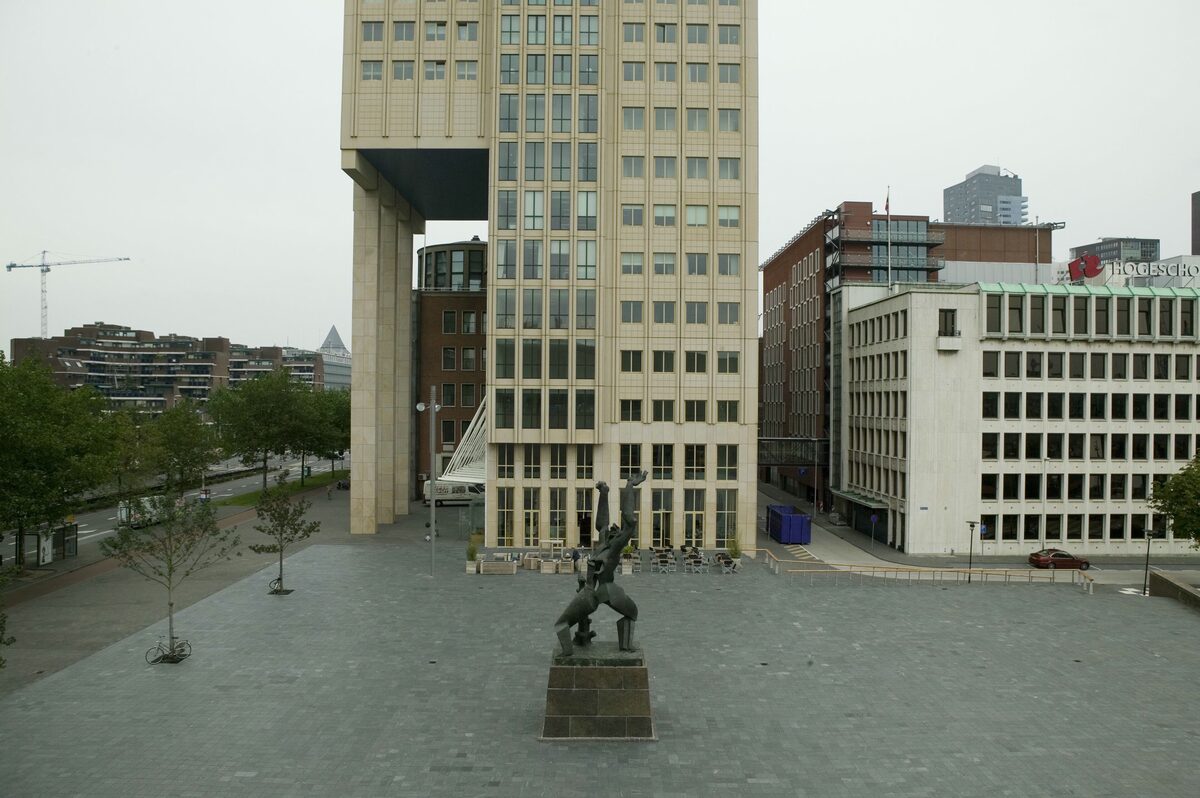 Zadkine's bronze statue The Destroyed City, a twisted figure with arms raised, standing on a square in front of a modern office tower
