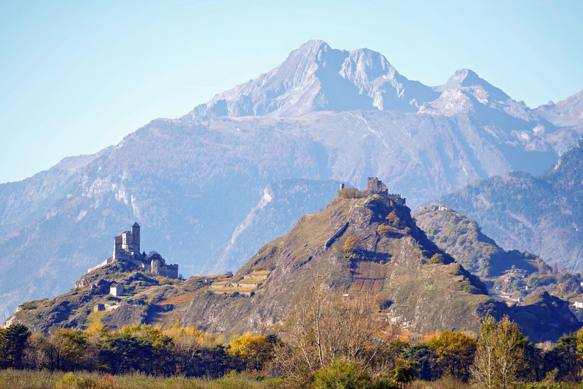 The castles of Valère and Tourbillon on their hills above Sion, with a high mountain behind