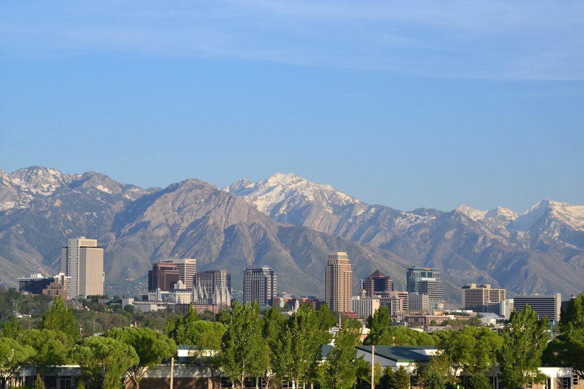 The downtown Salt Lake City towers in front of the steep, snow-capped Wasatch Range on a clear day