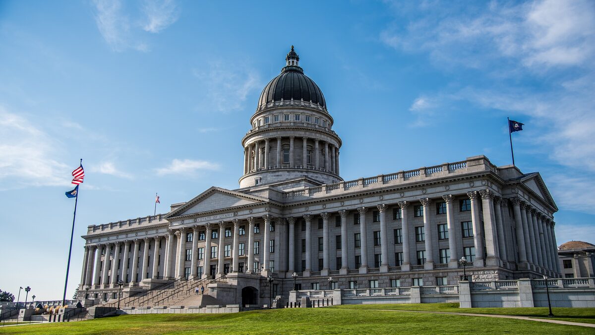 The Utah State Capitol with its dark copper dome and long colonnade, seen from the south lawn