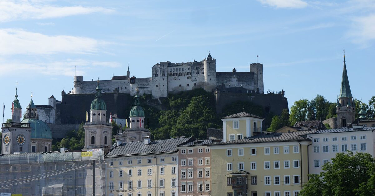 Hohensalzburg Fortress on its hill above the domes and towers of Salzburg's old town, seen from across the Salzach