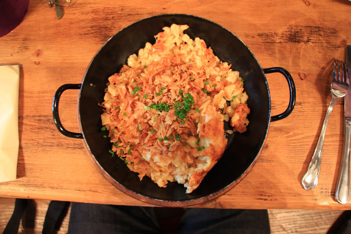Kasnocken, cheese noodles with fried onions, served in an iron pan