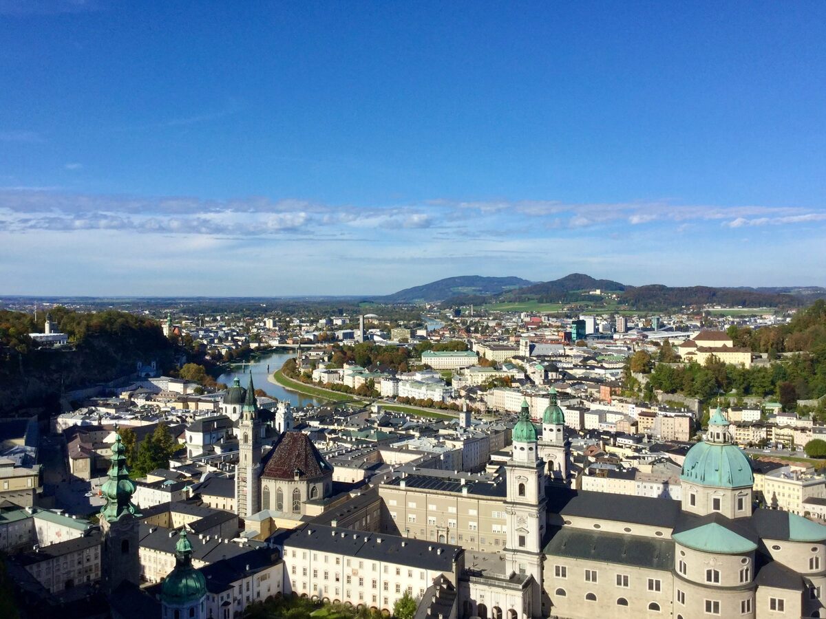 The domes and spires of Salzburg's old town and the Salzach river seen from above