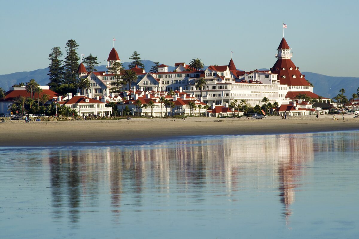 Coronado's wide sandy beach with the Hotel del Coronado reflected in the wet sand