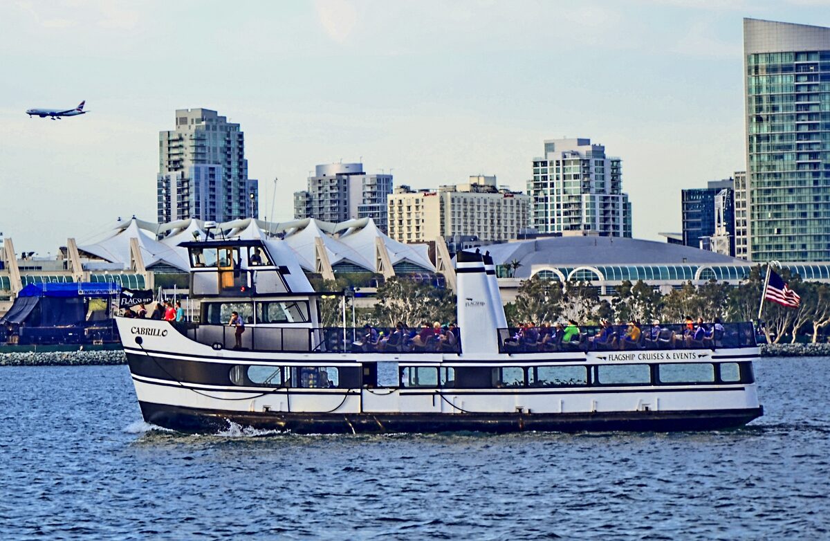 A harbor ferry crossing San Diego Bay with downtown behind it