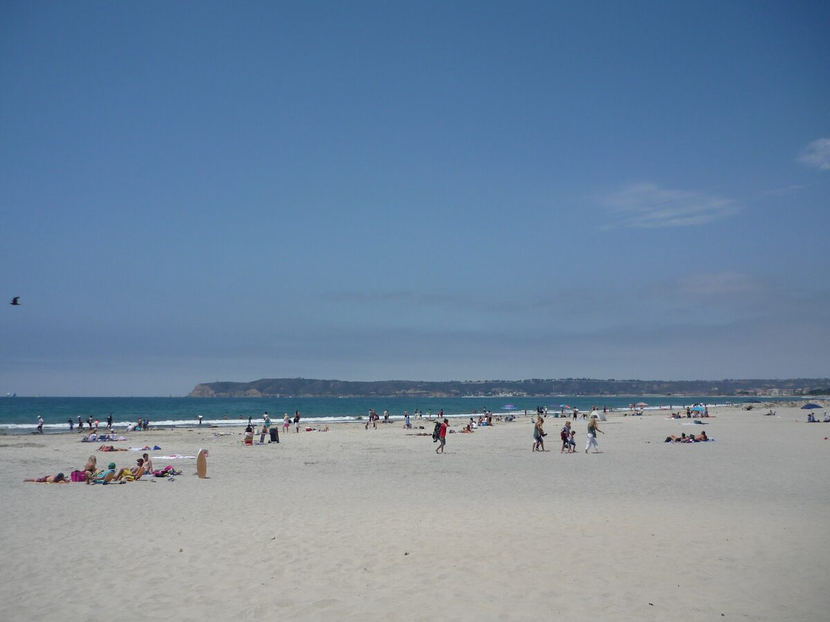Sunbathers on Coronado's wide white sand beach beside the Pacific