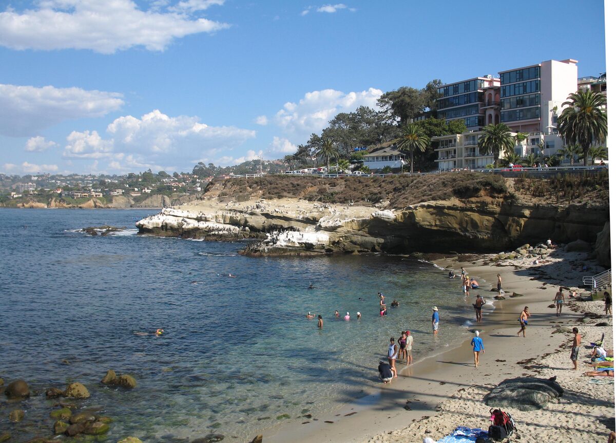 Swimmers and sunbathers on the small sandy beach at La Jolla Cove