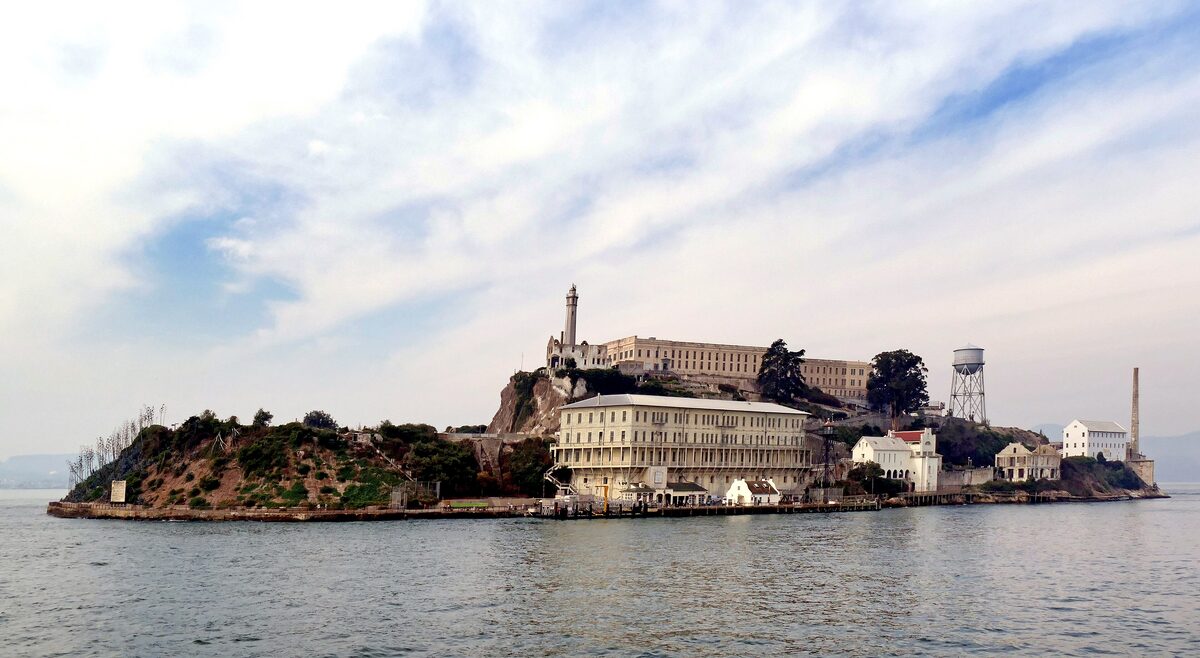 Alcatraz Island seen from the water, with the cellhouse, water tower and old prison buildings on the rock
