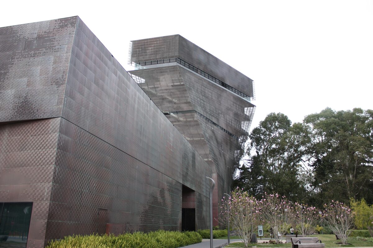 The copper-clad walls of the de Young Museum with the twisting Hamon Tower rising behind them
