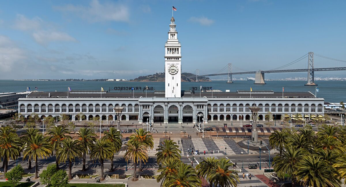 The Ferry Building with its clock tower facing the Embarcadero plaza, and the Bay Bridge behind