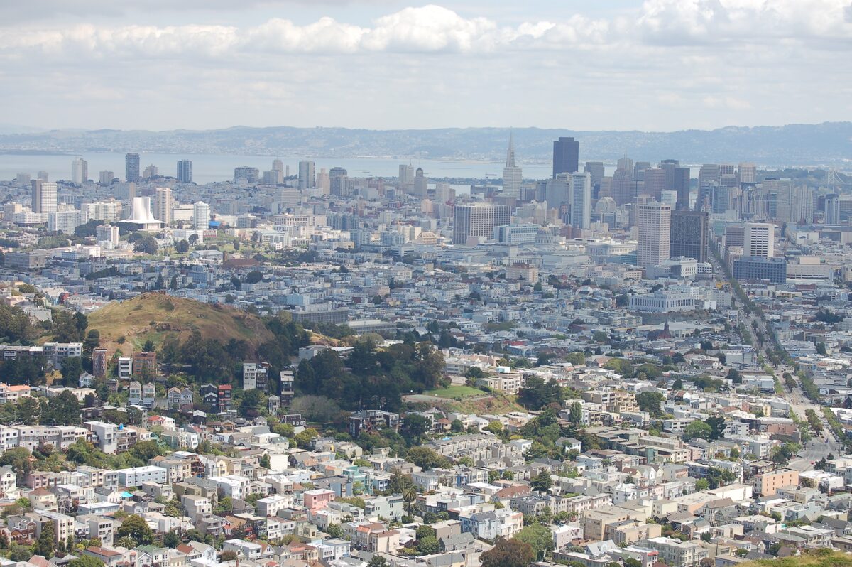 The downtown skyline and the street grid of the city below, seen from the summit of Twin Peaks on a clear day