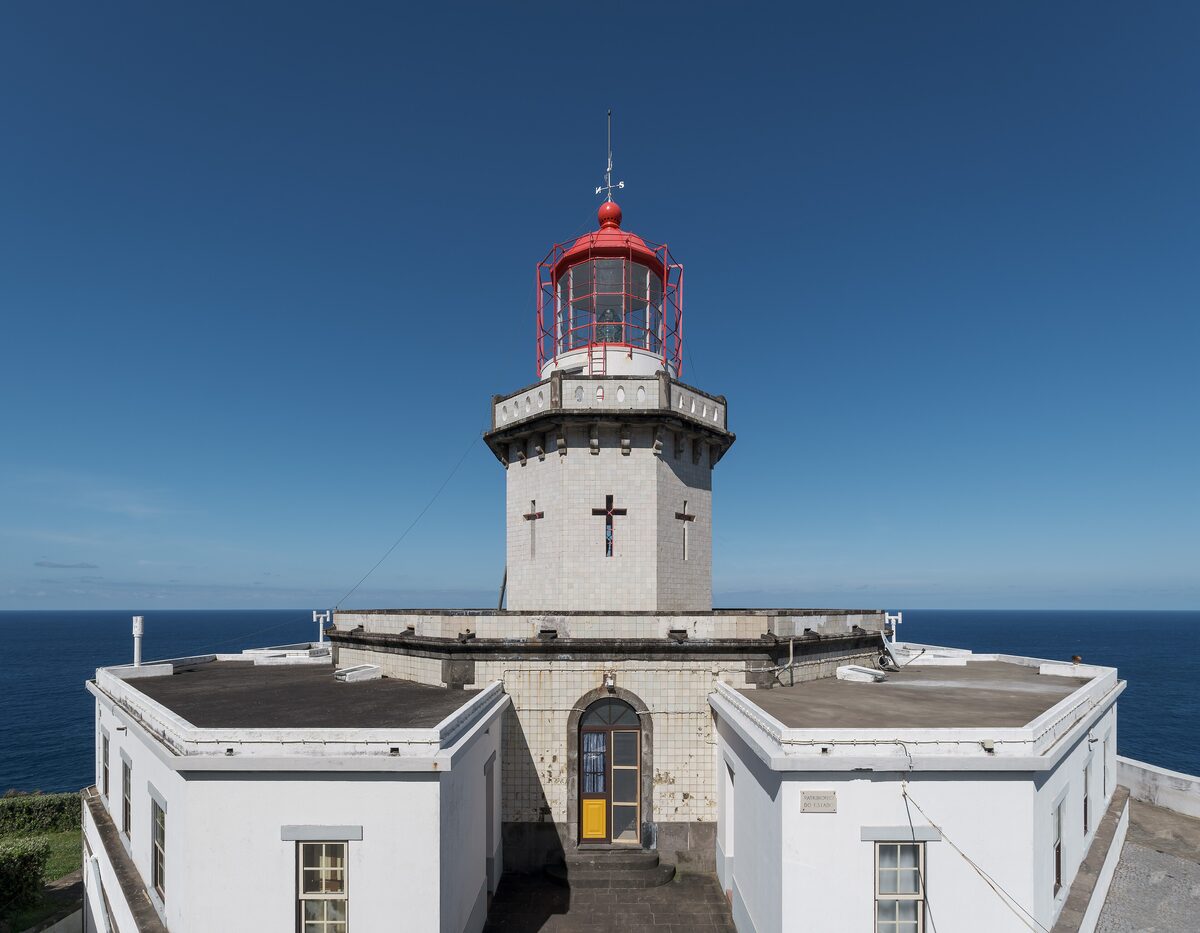 The white Arnel lighthouse with its red lantern on the cliffs of the northeast coast