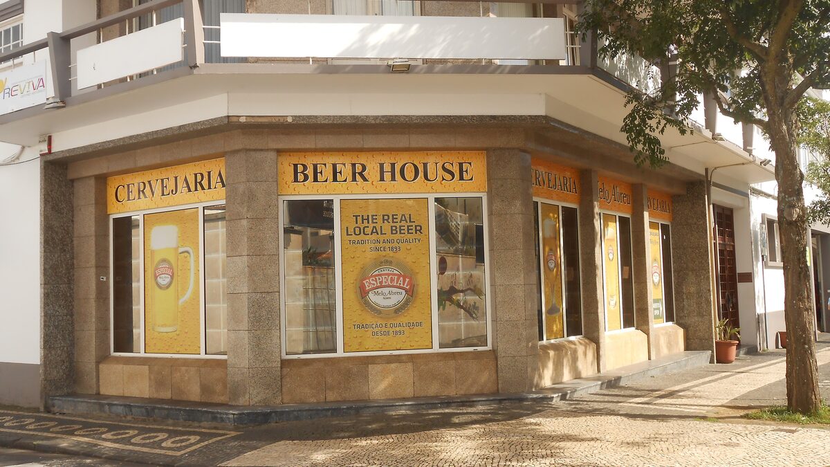 The yellow-fronted Cervejaria Melo Abreu beer house in Ponta Delgada, with Especial beer posters in the windows