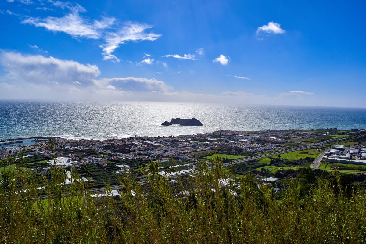 The small islet of Vila Franca off the coast, with the town and the sea beyond