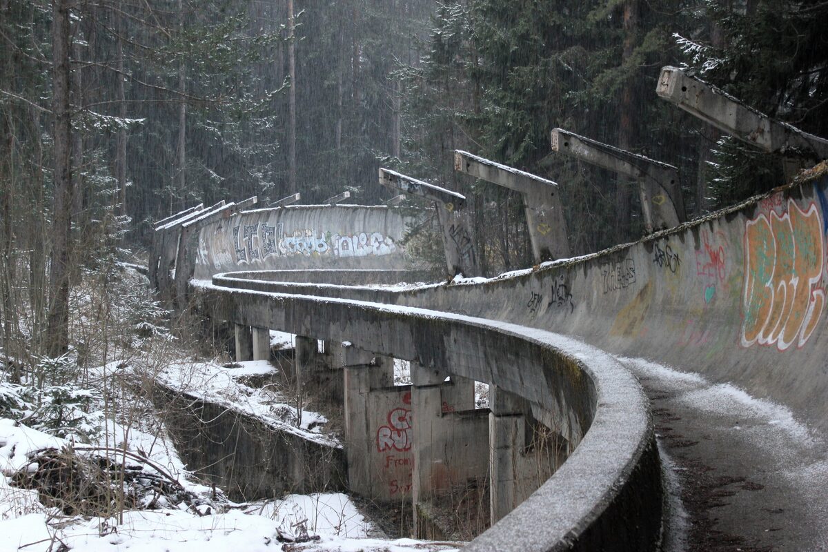 The 1984 Olympic bobsleigh track on Trebević in snow, its concrete channel curving through the forest
