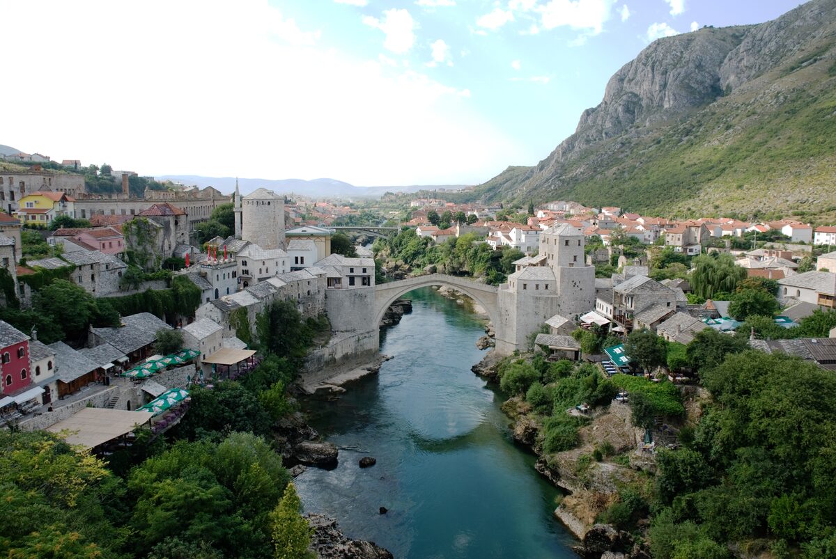 Mostar's Old Town from above, the Stari Most arch over the green Neretva and stone houses on both banks