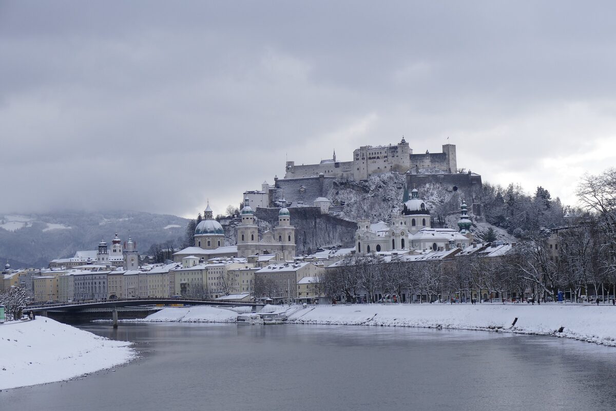 Salzburg's old town in snow, with the Hohensalzburg fortress above the Salzach river