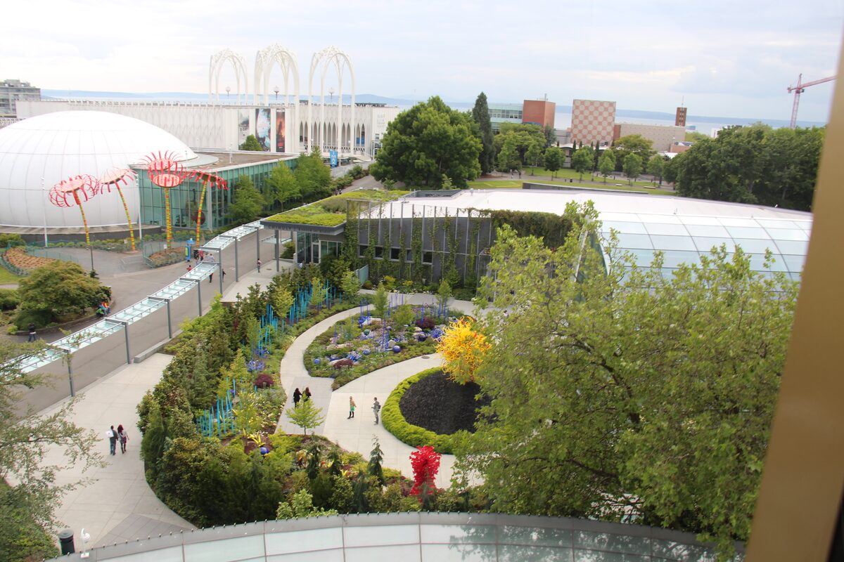 Chihuly Garden and Glass seen from above, with sculptures along the paths