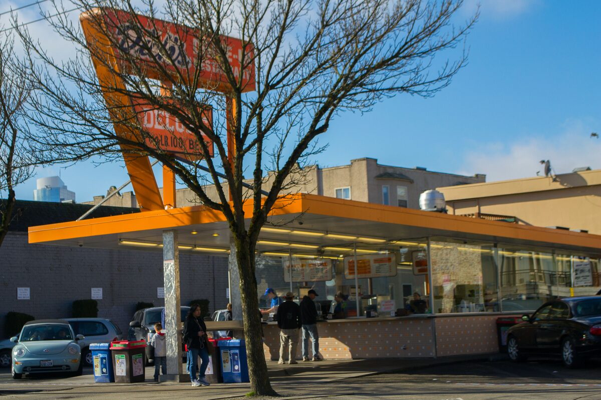 Walk-up counter and orange sign of a Dick's Drive-In