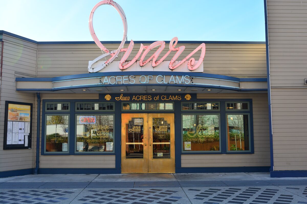 The pink neon sign above Ivar's Acres of Clams doors