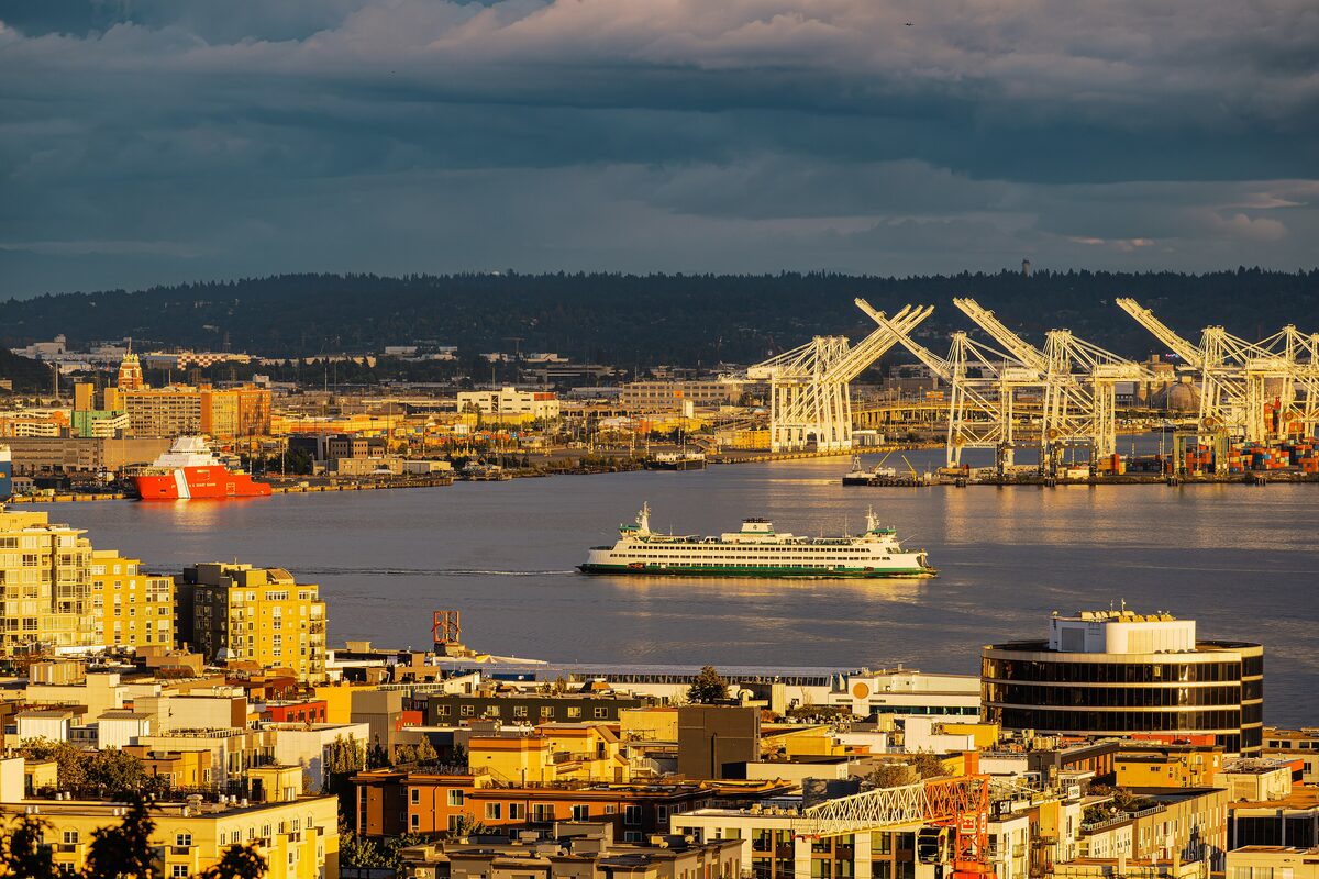 A Washington State ferry crossing Elliott Bay below Seattle's port cranes
